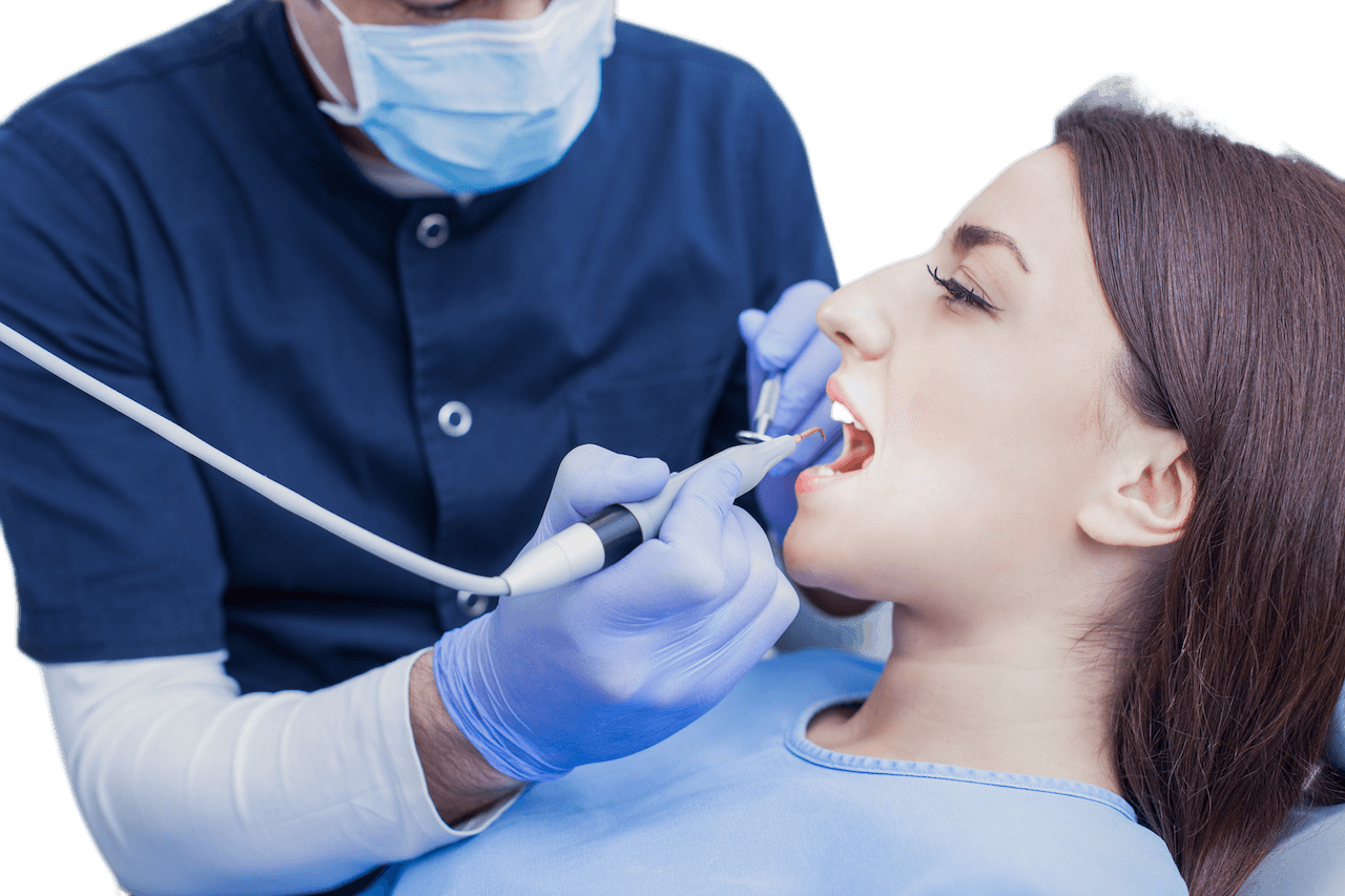 Woman receiving professional dental cleaning, promoting oral hygiene and maintaining a healthy smile.