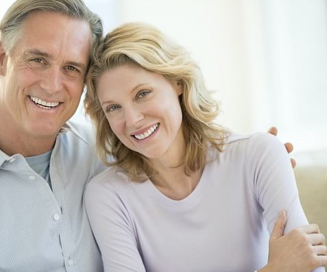 Senior couple with dental implants.