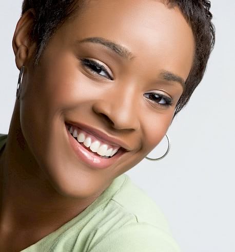 Woman with dental crowns smiling.