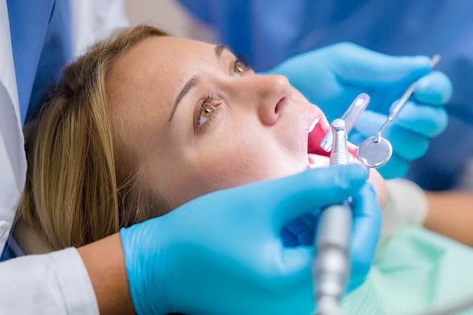 Woman undergoing dental crown procedure.