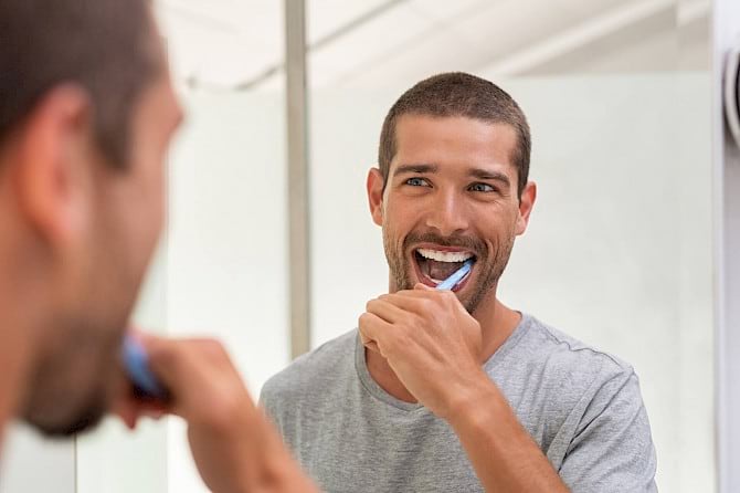 Man brushing teeth.