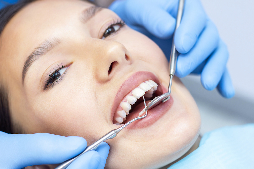 Periodontal cleaning procedure by dentist for treating gum disease.