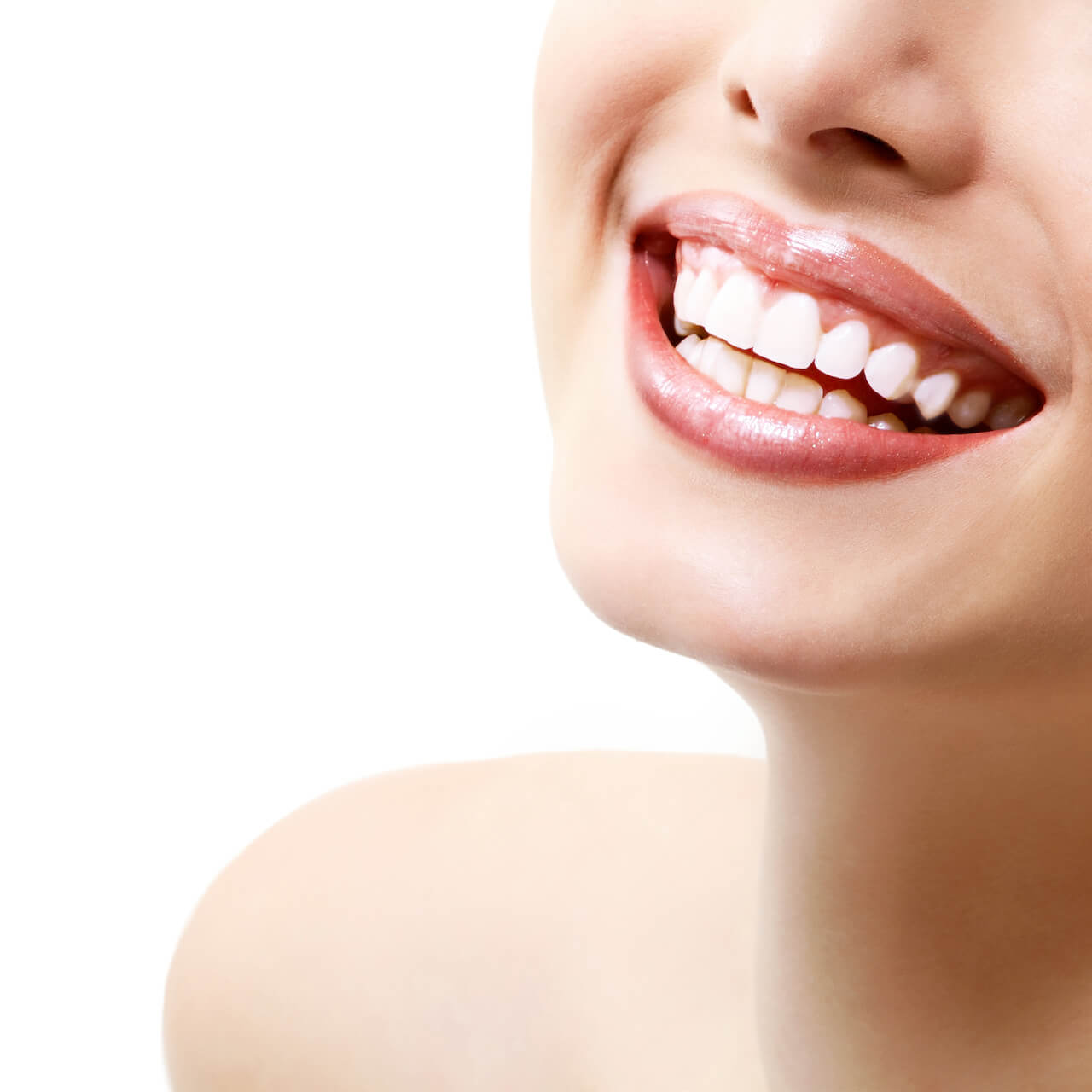 Woman showcasing perfectly aligned and sparkling white teeth.