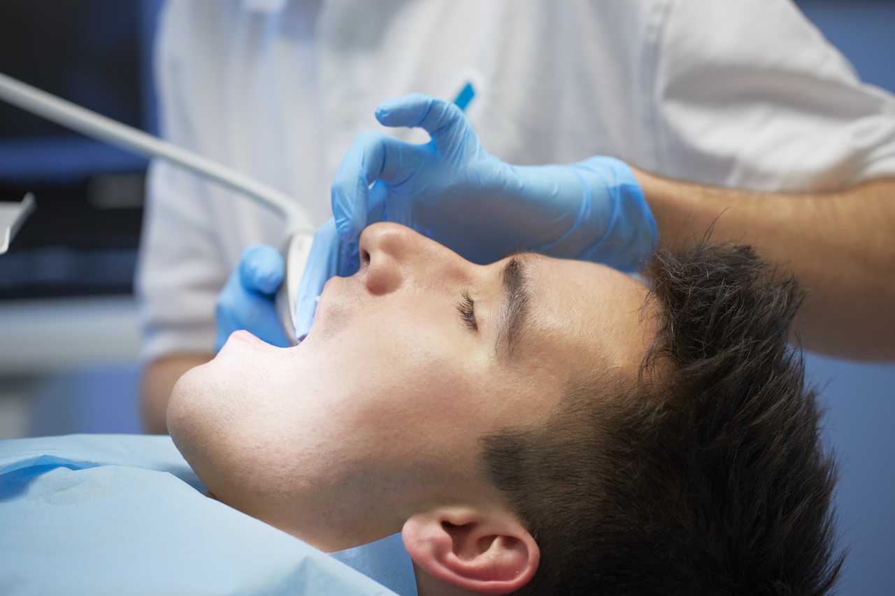 Man in his regular schedule of dental examinations and cleanings.