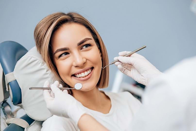 Woman visiting dentist for a regular dental checkup.